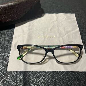 Gucci prescription glasses with black frames and design in the sides